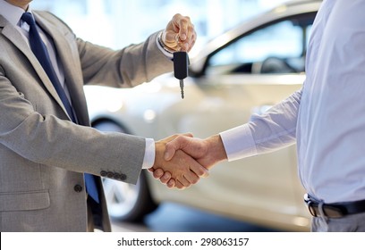 Professional handshake in car dealership
